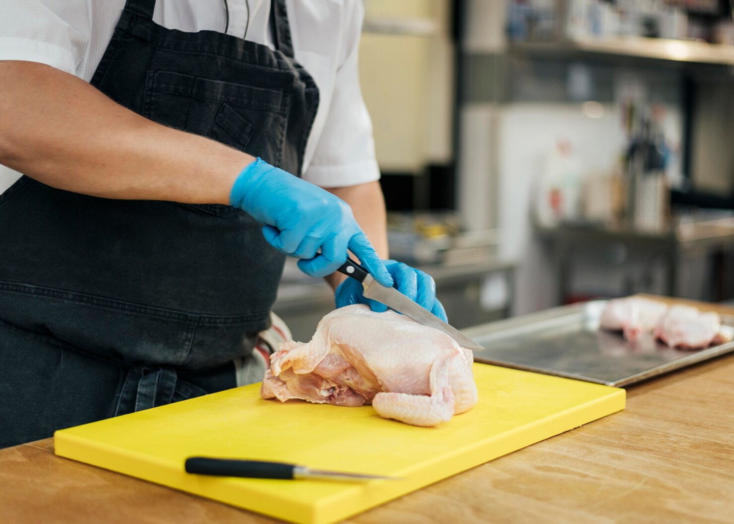side view chef with apron gloves cutting chicken 23 2148763121